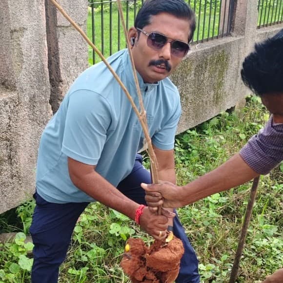 Vikram Gangadhar Ganjare planting a tree sapling during plantation drive